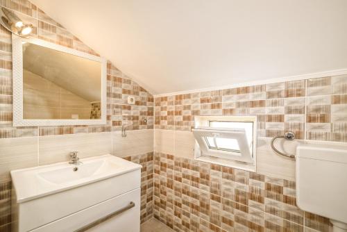 a bathroom with a sink and a mirror at Apartments Marko in Vir