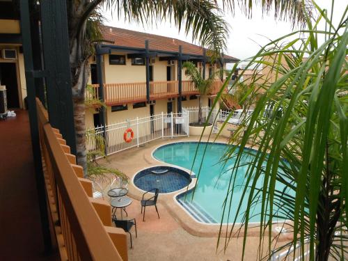 a view of a pool from the balcony of a hotel at The Central Hotel Motel Lakes Entrance in Lakes Entrance