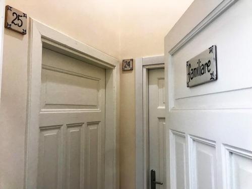 a door in a hallway with numbered signs on it at Hotel L'Ariana ISOLE EOLIE - UNA Esperienze in Leni