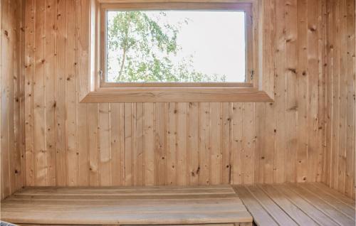 an empty room with a window in a wooden wall at Beautiful Home In Nässjö With Kitchen in Nässjö