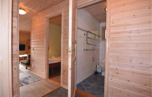 a bathroom with wooden walls and a shower stall at Beautiful Home In rjng With 3 Bedrooms And Wifi in Årjäng