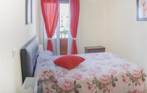 una camera con letto e finestra con tende rosse di Stunning Apartment In Ayamonte With Wifi ad Ayamonte