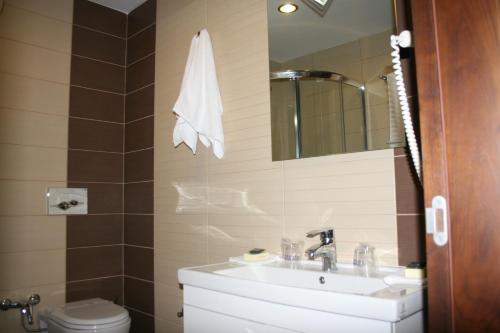 a bathroom with a sink and a toilet and a mirror at Hotel Franca in Bijelo Polje