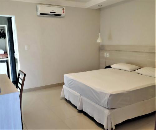a bedroom with a bed and a air conditioner on the wall at Max Hotel in Arcos