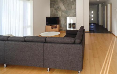 a living room with a couch and a table at Four-Bedroom Holiday Home Farsund With Sea View 09 in Farsund
