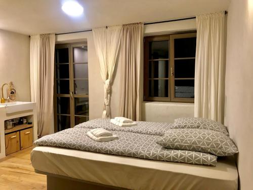 a bedroom with a bed with two towels on it at Summer House Bovec in Bovec