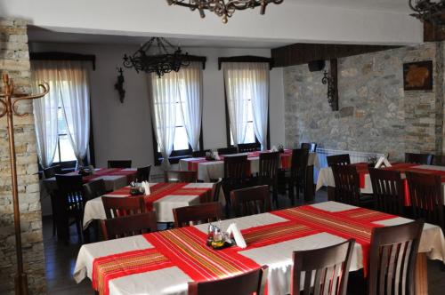a restaurant with red and white tables and chairs at Galabova Guesthouse in Delchevo