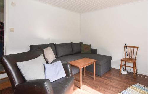a living room with a couch and a table at 2 Bedroom Stunning Home In Strömstad in Lommeland