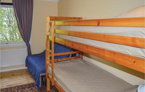 two bunk beds in a room with a window at Nice Home In Färentunna in Ölsta