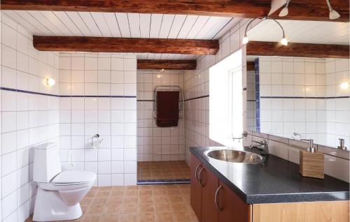 La salle de bains est pourvue de toilettes et d'un lavabo. dans l'établissement Amazing Home In Lderup With House A Panoramic View, à Löderup