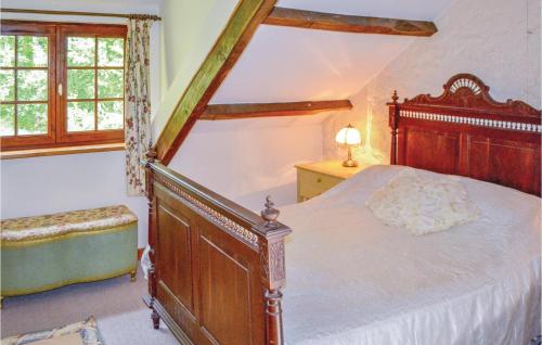 a bedroom with a large wooden bed and a window at Stunning Home In Guern With 1 Bedrooms And Wifi in Guern