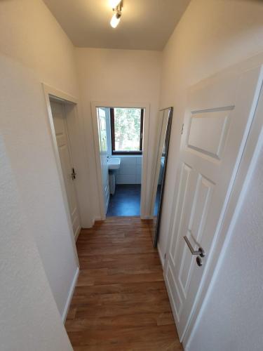 a hallway with a door leading to a bathroom at Ferienwohnung Muldental in Grimma