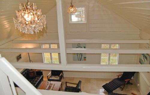 a staircase in a house with a chandelier at Lovely Home In Mellerud With Kitchen in Mellerud