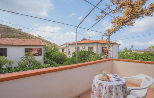 a table and chairs on the balcony of a house at Casa Virginio in Pomonte