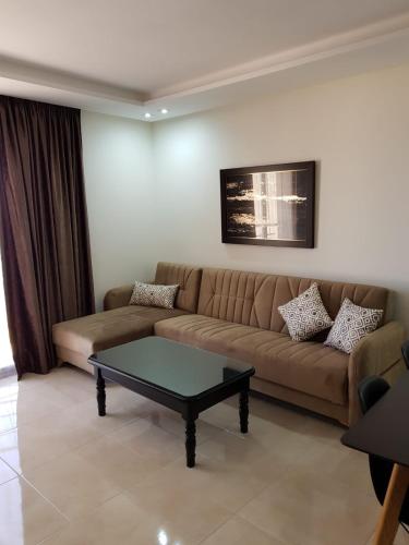 a living room with a couch and a coffee table at Saramica Seaside apartment in Fnidek
