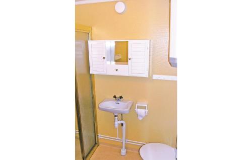 a bathroom with a sink and a toilet at Sjöstugan in Aneby
