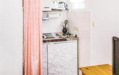 a small kitchen with a stove and a sink at Holiday Home Harzgerode Ot Neudorf Lxxiii in Neudorf