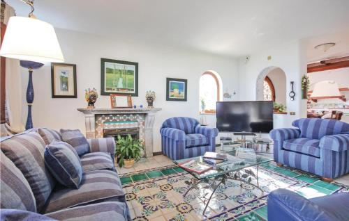 a living room with blue couches and a fireplace at Villa Sole in Bosco