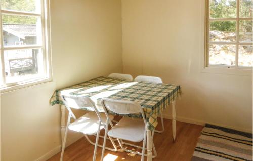 a table and chairs in a corner of a room at Four-Bedroom Holiday Home In Trosa in Trosa