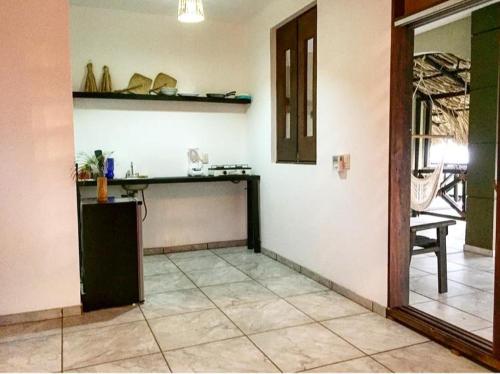 a room with a counter and a table on a wall at Beach Front Guesthouse in Puerto Escondido