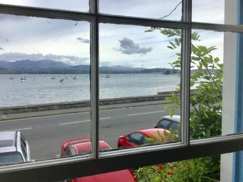 a view from a window looking out at the water at The Suites At Ty Anne in Beaumaris