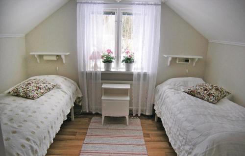 two twin beds in a room with a window at Awesome Home In Skeppshult With 2 Bedrooms in Skeppshult
