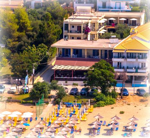 an aerial view of a beach with chairs and umbrellas at Hotel Loukas Vrachos in Paralia Vrachou