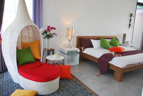 a room with a bed and a hammock and a bed and chair at Lotus Hostel Beicheng Zhuang in Luodong