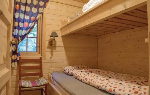 a bedroom with a bunk bed in a log cabin at 3 Bedroom Beautiful Home In seral in Åseral