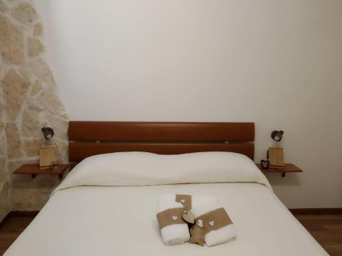 a bedroom with a bed with two towels on it at Historical Domus in Anagni