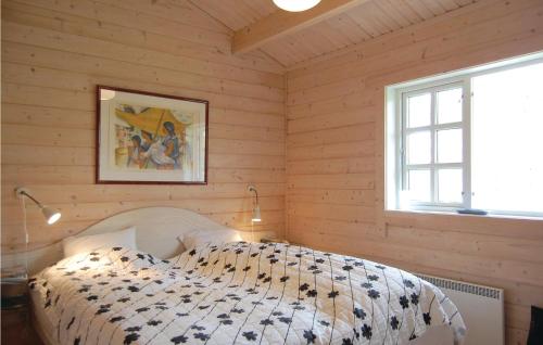una camera con un letto in una stanza con pareti in legno di 4 Bedroom Nice Home In Osby a Osby