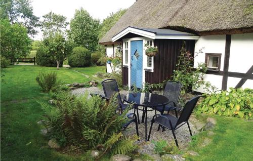 a table and chairs in front of a cottage at Nice Home In Kvidinge With Wifi in Kvidinge
