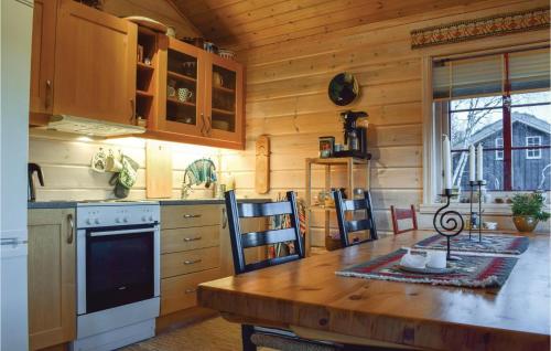 a kitchen with a table and a stove top oven at Three-Bedroom Holiday Home In Aseral in Åseral