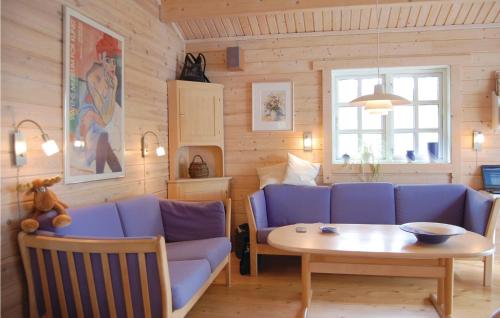 a living room with a blue couch and a table at Amazing Home In Osby With Wifi in Osby