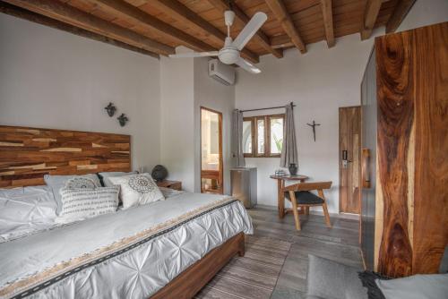 a bedroom with a large bed and a ceiling fan at Villa San Juan Bed&Breakfast in Nuevo Vallarta 