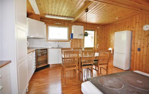a kitchen and dining room with a table and chairs at 2 Bedroom Stunning Home In Uddevalla in Ammenäs