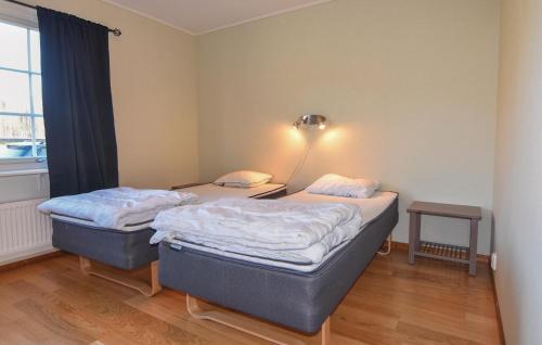 two twin beds in a room with a window at Gorgeous Home In Svanskog With Wifi in Svanskog