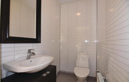 a white bathroom with a sink and a toilet at Gorgeous Home In Svanskog With Wifi in Svanskog