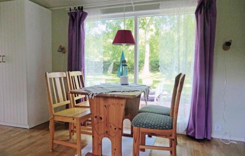 ein Esszimmer mit einem Tisch, Stühlen und einem Fenster in der Unterkunft Lovely Home In Frjestaden With Ethernet Internet in Färjestaden