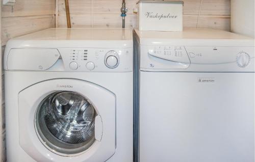 a washing machine and a dryer in a room at Amazing Home In Hol With Sauna in Seim