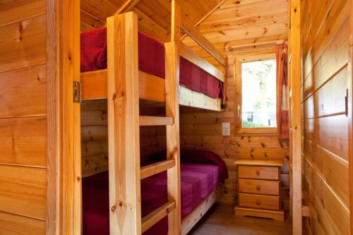 a log cabin with two bunk beds in it at Bungalows Verneda Mountain Resort in Arrós