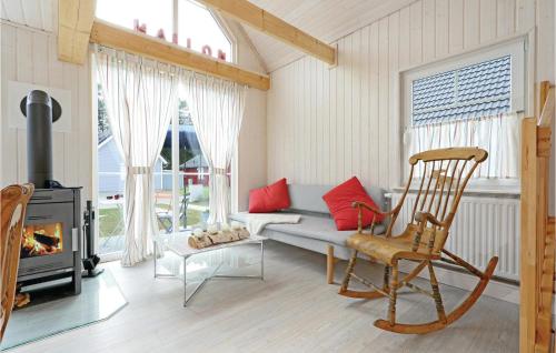 a living room with a couch and a fireplace at Beautiful Home In Zerpenschleuse in Zerpenschleuse