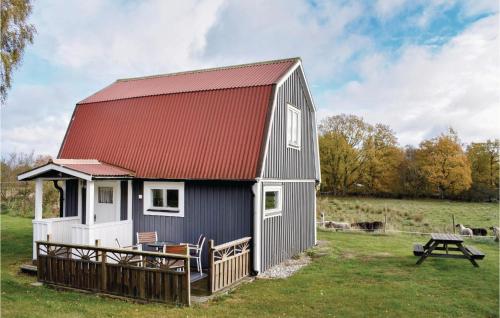 a barn with a red roof and a picnic table at 2 Bedroom Gorgeous Home In Jämjö in JÃ¤mjÃ¶