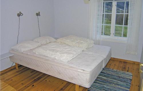 an unmade bed in a room with a window at Amazing Home In Skei I Jlster With House Sea View in Årdal