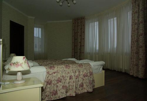 Postel nebo postele na pokoji v ubytování Hotel Deluxe