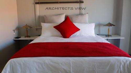 a bedroom with a red and white bed with two lamps at ARCHITECT'S VIEW in Durban