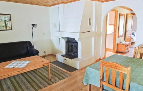 a living room with a couch and a fireplace at 2 Bedroom Beautiful Home In Bolmsö in Skeda