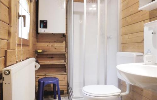 a bathroom with a toilet and a sink and a stool at 2 Bedroom Lovely Home In Schlitz-rimbach in Rimbach