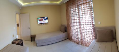 a small room with a bed and a window at Apartments Exclusive in Belgrade