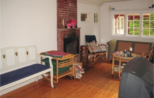 a living room with a fireplace and chairs at Nice Home In Ystad With 2 Bedrooms And Internet in Ystad